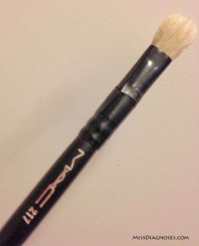 Makeup brush wrapped with black electrical tape